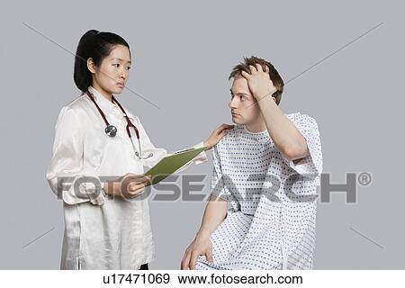 Female doctor comforting an upset patient View Large Photo Image Stock Photo - Female doctor comforting an upset patient. Fotosearch