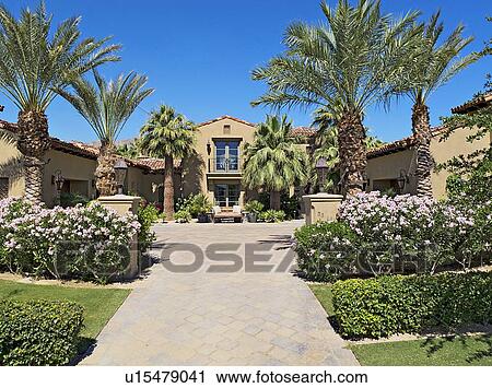 Stock Image - Front entrance facade of luxury villa. Fotosearch