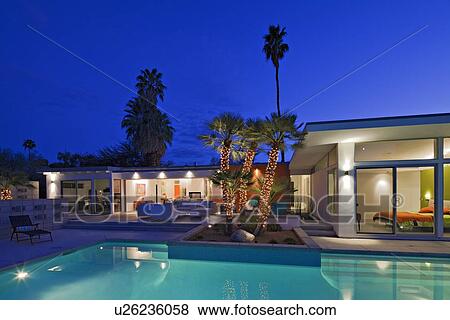 Illuminated patio at poolside in luxurious villa at night View Large Photo Image Stock Photo - Illuminated patio at poolside in luxurious villa at night. Fotosearch