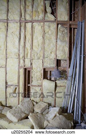 Picture - Incomplete stone wall with rods and rocks. Fotosearch