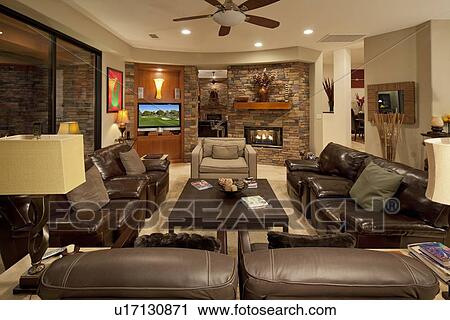 Stock Image - Leather seating furniture in living room of luxury mansion. Fotosearch