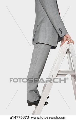 Low section view of a businessman standing on a ladder View Large Photo Image Stock Image - Low section view of a businessman standing on a ladder. Fotosearch