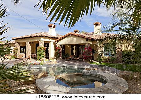 Stock Photo - Luxury villa with swimming pool in foreground. Fotosearch
