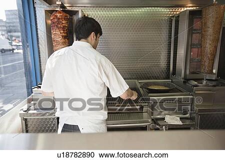 mid adult man working in kebab shop View Large Photo Image Stock Image - mid adult man working in kebab shop. Fotosearch