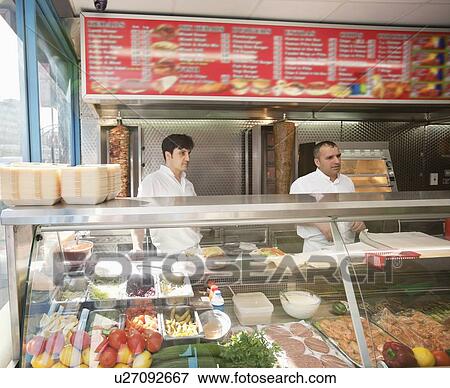 mid adult men working in kebab shop View Large Photo Image Stock Photo - mid adult men working in kebab shop. Fotosearch