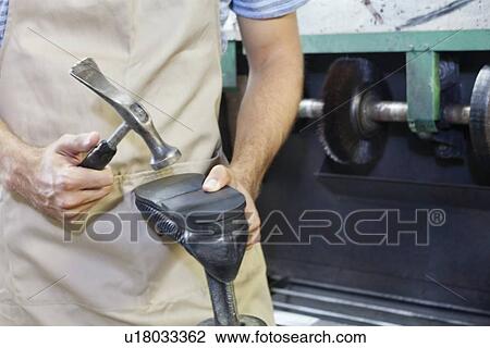Midsection of shoemaker hammering shoe sole in workshop View Large Photo Image Stock Image - Midsection of shoemaker hammering shoe sole in workshop. Fotosearch