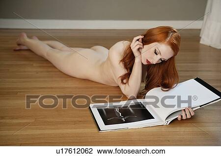 Naked Woman Lying On Wooden Floor Reading Book Stock Image