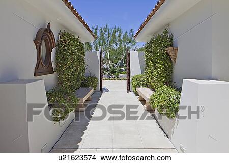 Picture - Narrow gateway of luxury villa. Fotosearch