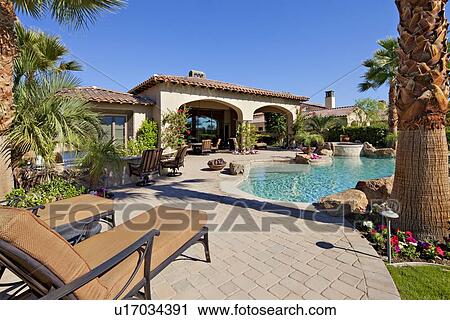 Outdoors seating furniture near swimming pool in luxury villa View Large Photo Image Stock Image - Outdoors seating furniture near swimming pool in luxury villa. Fotosearch