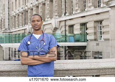 Portrait of a confident African American male surgeon standing with arms crossed View Large Photo Image Stock Image - Portrait of a confident African American male surgeon standing with arms crossed. Fotosearch