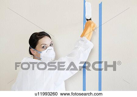 Portrait of a female worker in protective workwear painting wall View Large Photo Image Stock Image - Portrait of a female worker in protective workwear painting wall. Fotosearch