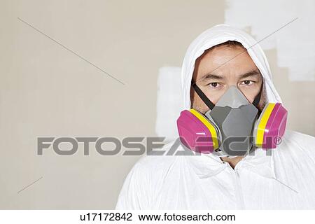 Stock Image - Portrait of a manual worker wearing a dust mask. Fotosearch