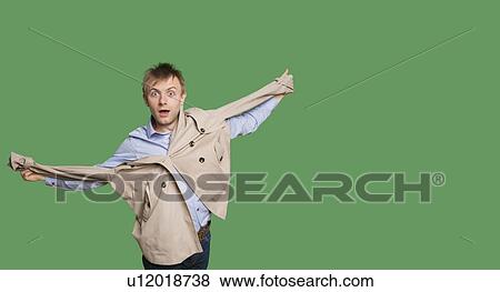 Stock Photo - Portrait of amazed young man with jacket over colored background. Fotosearch
