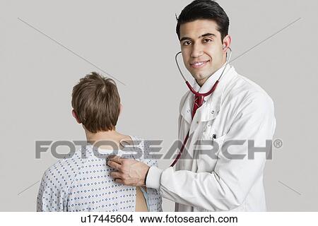 Portrait of an Indian doctor examining patient View Large Photo Image Picture - Portrait of an Indian doctor examining patient. Fotosearch