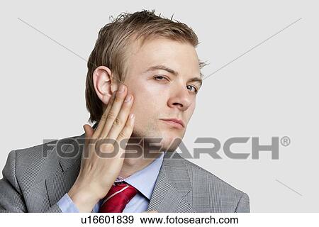 Portrait of businessman with hand on chick looking sideways over colored background View Large Photo Image Stock Photo - Portrait of businessman with hand on chick looking sideways over colored background. Fotosearch