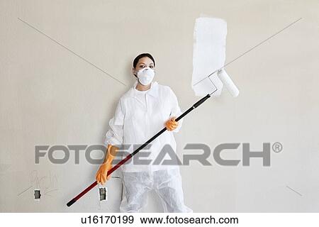 Portrait of female worker in protective workwear holding a paint roller View Large Photo Image Stock Photo - Portrait of female worker in protective workwear holding a paint roller. Fotosearch