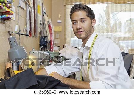 Portrait of handsome young tailor with sewing machine View Large Photo Image Stock Image - Portrait of handsome young tailor with sewing machine. Fotosearch