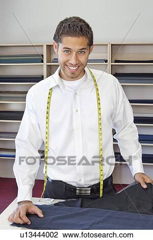 Portrait of happy young tailor in shop View Large Photo Image Stock Image - Portrait of happy young tailor in shop. Fotosearch