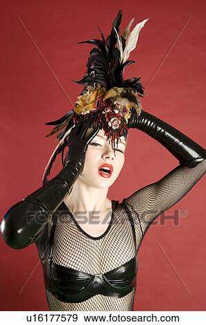 Portrait of pinup woman wearing feather headgear over colored background View Large Photo Image Stock Photo - Portrait of pinup woman wearing feather headgear over colored background. Fotosearch