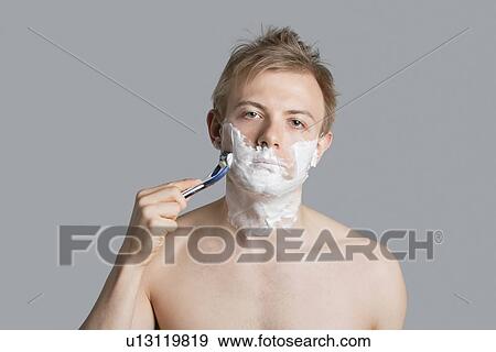 Portrait of tired man shaving over colored background View Large Photo Image Stock Photo - Portrait of tired man shaving over colored background. Fotosearch