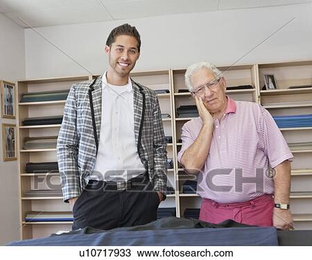 Stock Image - Portrait of young customer with shop owner. Fotosearch