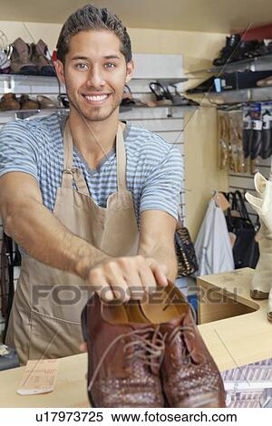 Portrait of young man giving handmade shoes View Large Photo Image Stock Photography - Portrait of young man giving handmade shoes. Fotosearch
