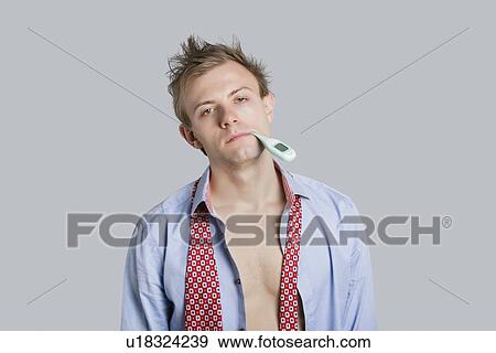 Portrait of young man in unbuttoned shirt with thermometer in mouth over colored background View Large Photo Image Stock Photo - Portrait of young man in unbuttoned shirt with thermometer in mouth over colored background. Fotosearch
