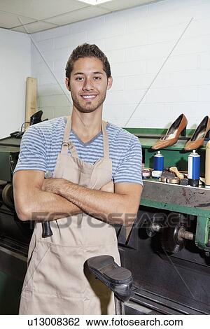 Portrait of young shoemaker standing with arms crossed in workshop View Large Photo Image Stock Image - Portrait of young shoemaker standing with arms crossed in workshop. Fotosearch