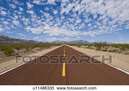 Remote Kelbaker road below cloudy sky View Large Photo Image Stock Photography - Remote Kelbaker road below cloudy sky. Fotosearch