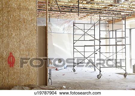 Scaffolding in a empty room at construction site View Large Photo Image Picture - Scaffolding in a empty room at construction site. Fotosearch