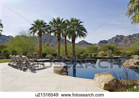 Stock Photo - Scenic view mountains with swimming pool in foreground. Fotosearch