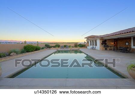 Stock Photograph - Scenic view of swimming pool with landscape in background. Fotosearch