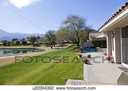 Stock Image - Scenic view outside of luxury mansion. Fotosearch