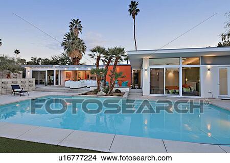 Picture - Swimming pool in front of luxurious villa. Fotosearch