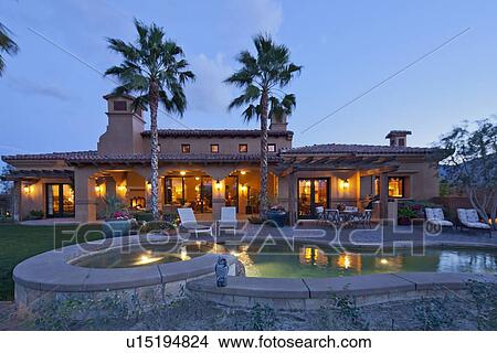 Picture - Swimming pool in front of luxury mansion. Fotosearch