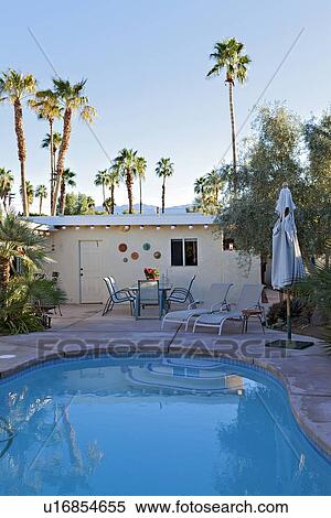 Swimming pool with outdoor seating furniture in luxury villa View Large Photo Image Stock Photography - Swimming pool with outdoor seating furniture in luxury villa. Fotosearch
