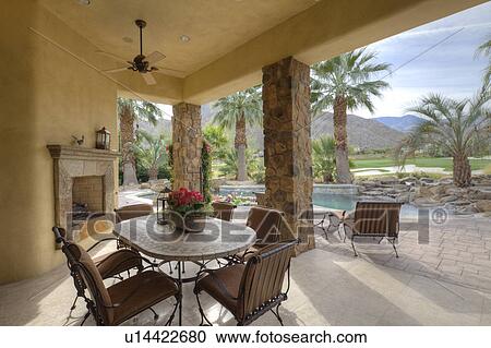Table and chair in patio of luxury manor house View Large Photo Image Stock Image - Table and chair in patio of luxury manor house. Fotosearch