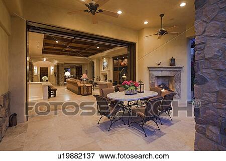 Table and chair in patio with living room in background View Large Photo Image Stock Photo - Table and chair in patio with living room in background. Fotosearch