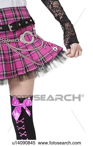 Torso of a young woman holding skirt over white background View Large Photo Image Stock Photography - Torso of a young woman holding skirt over white background. Fotosearch