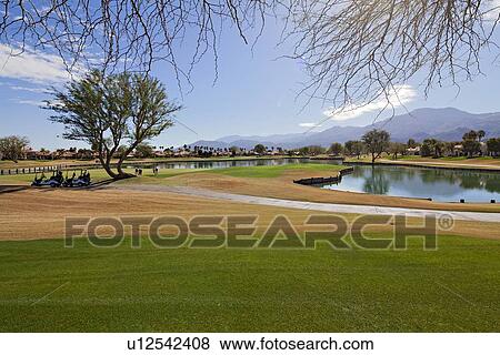 Stock Photo - View of landscape with mountains in background. Fotosearch