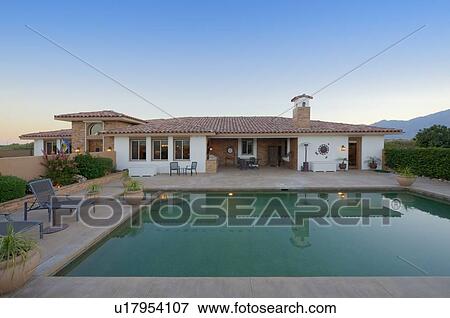 Stock Photo - View of luxurious villa with swimming pool in foreground. Fotosearch