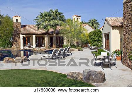 Stock Photo - View of luxury mansion with swimming pool. Fotosearch