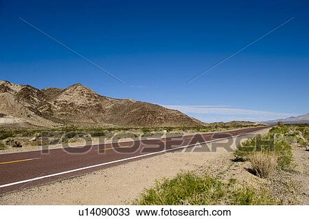 View of remote Kelbaker road below clear blue sky View Large Photo Image Stock Image - View of remote Kelbaker road below clear blue sky. Fotosearch