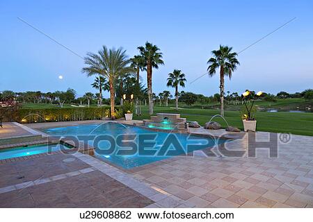 Stock Image - View of swimming pool with lawn in background. Fotosearch