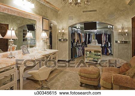 Stock Photography - View of wardrobe in dressing room of mansion. Fotosearch