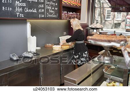 Young woman working in bakery View Large Photo Image Stock Image - Young woman working in bakery. Fotosearch