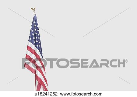 Stock Image - American flag over gray background. Fotosearch
