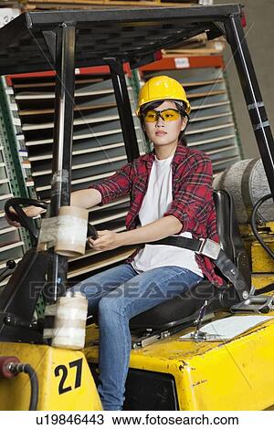 Asian female industrial worker driving forklift truck View Large Photo Image Stock Image - Asian female industrial worker driving forklift truck. Fotosearch