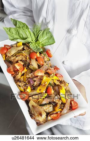 Close-up of hands holding salad in serving dish View Large Photo Image Picture - Close-up of hands holding salad in serving dish. Fotosearch