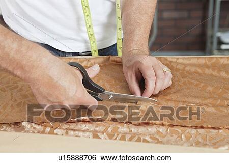 Close-up of male tailor cutting fabric View Large Photo Image Stock Photograph - Close-up of male tailor cutting fabric. Fotosearch